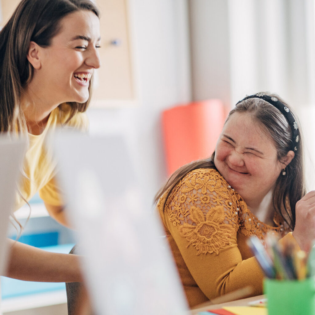 Disability health care art workshop.Creative painting on canvas and down syndrome people and cerebral palsy doing an art project