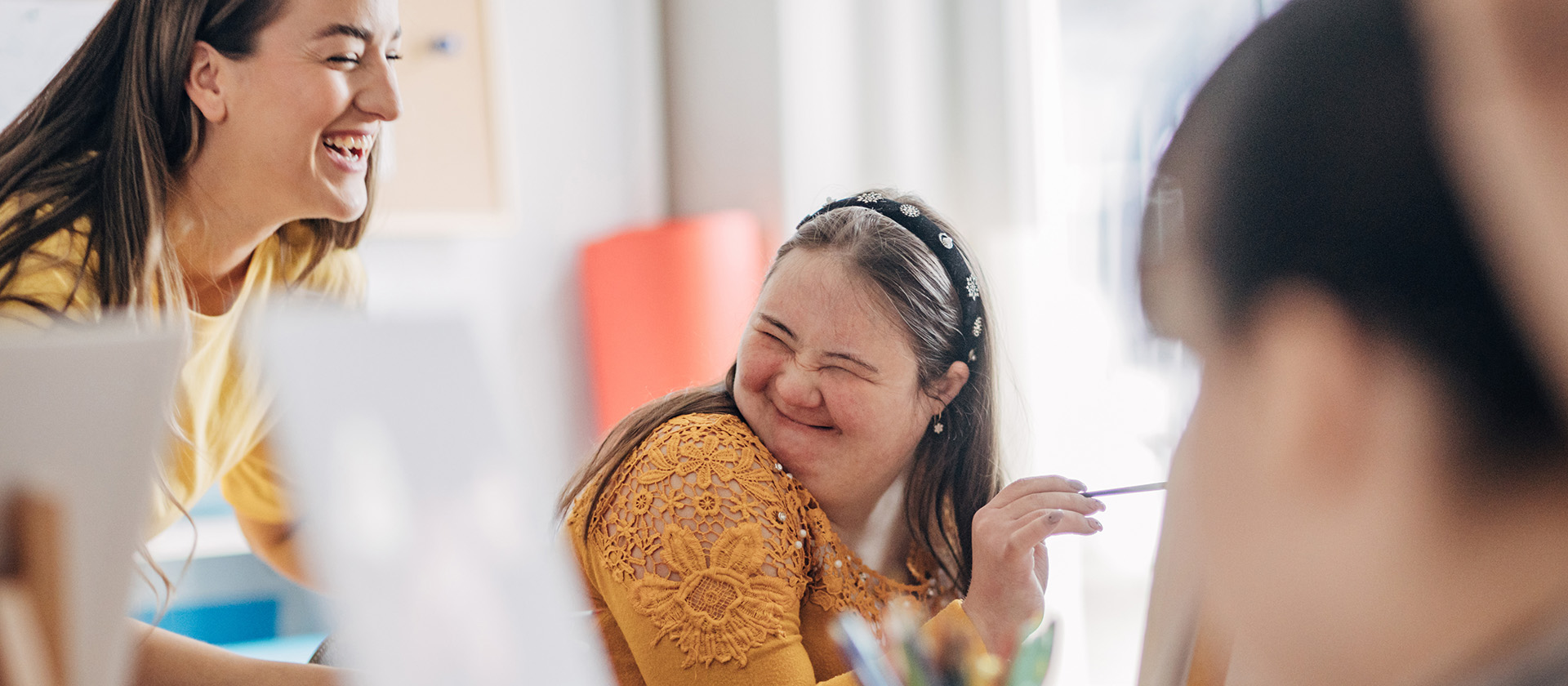 Disability health care art workshop.Creative painting on canvas and down syndrome people and cerebral palsy doing an art project