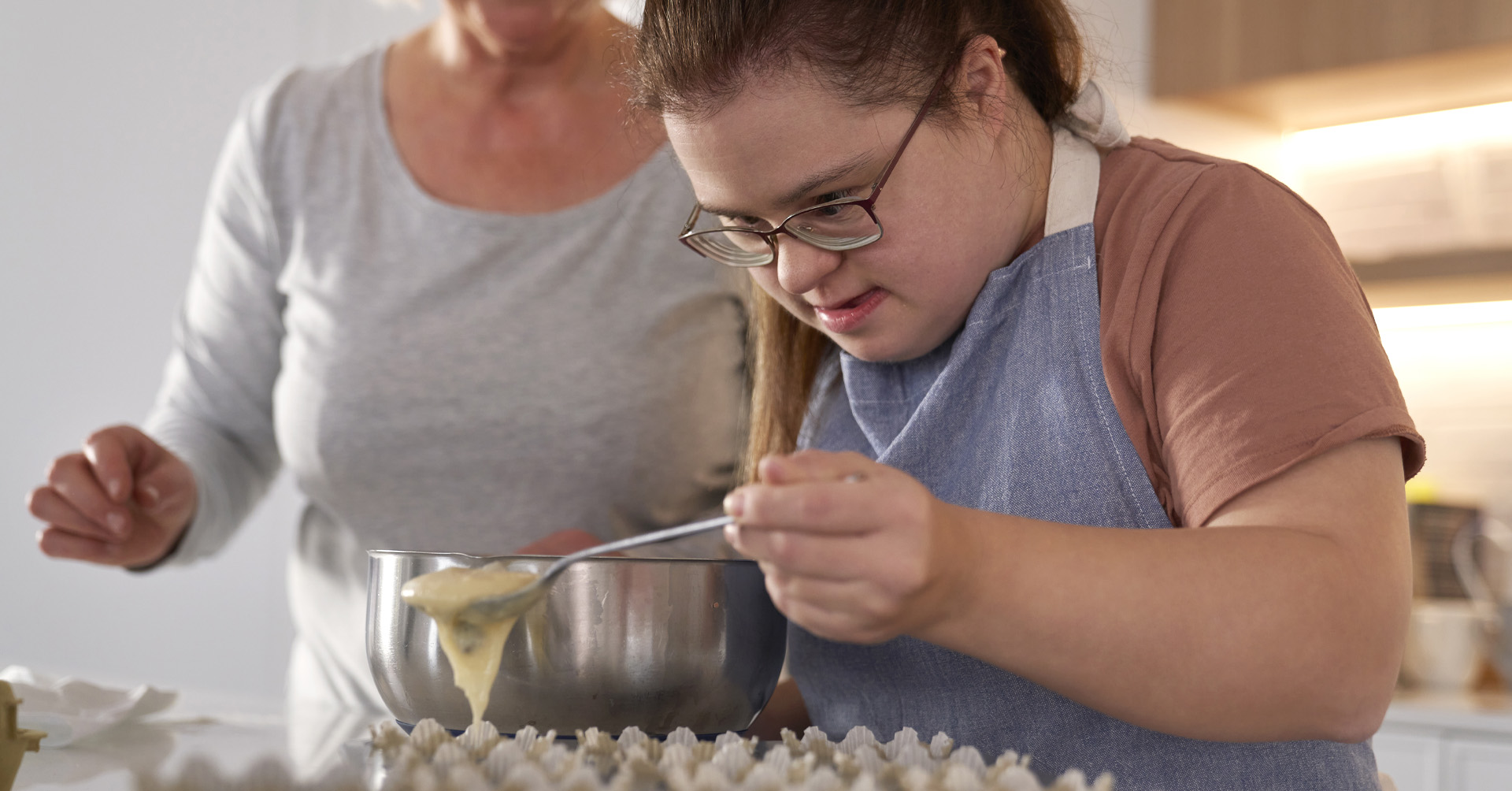 Girl with Down Syndrome gets help learning life skills in the kitchen